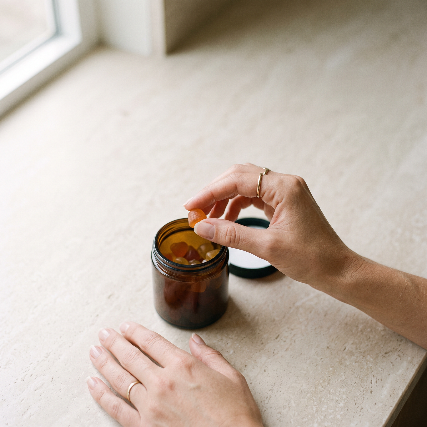 TRIADA ritual - hand lifting a gummy from a jar